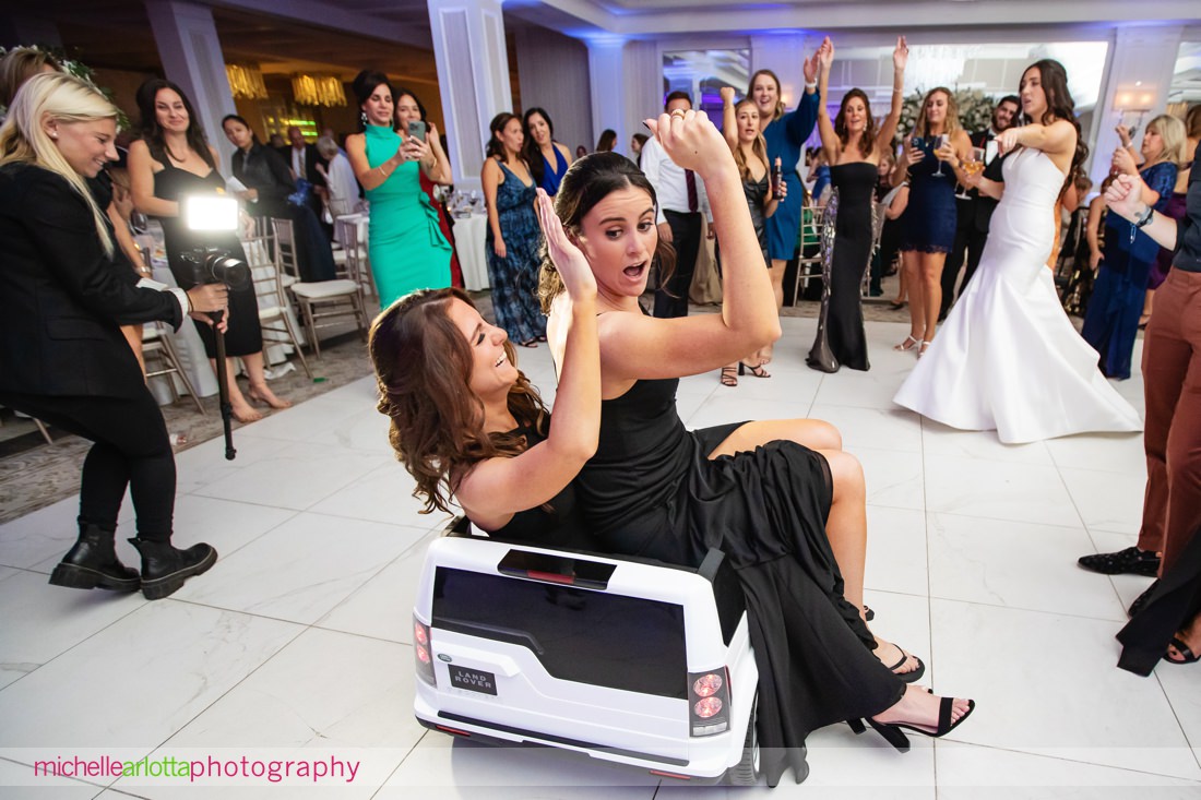 Edgewood Country Club wedding NJ reception two bridesmaids ride on the dance floor in little car