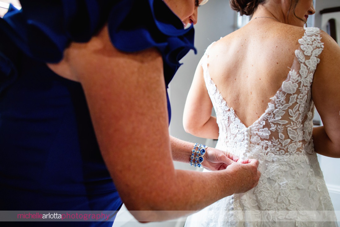 Phoenixville PA bride prep detail of putting dress on