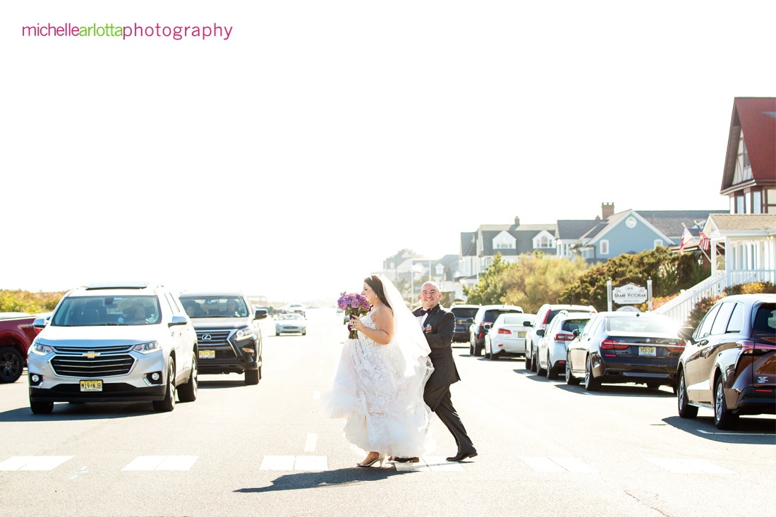 The Breakers by the ocean nj wedding bride and groom crossing the street to go to the beach