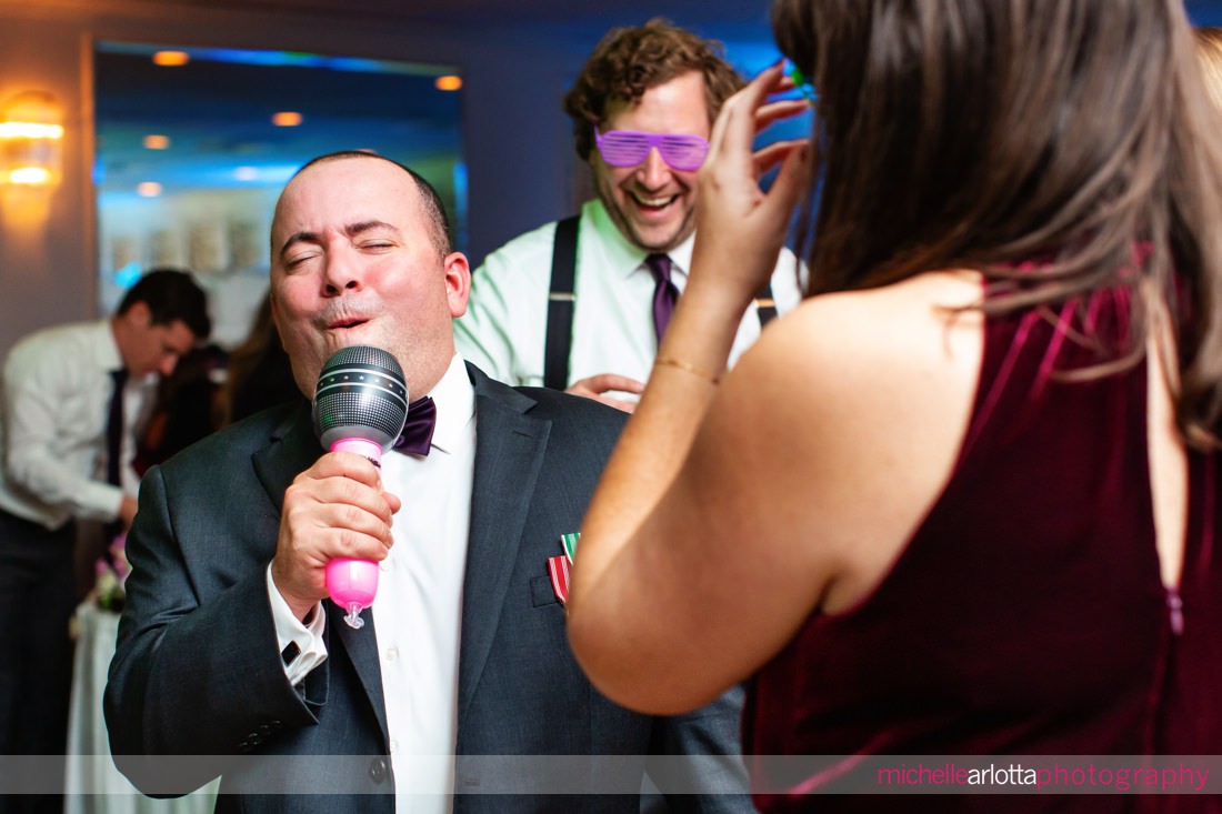 The Breakers on the Ocean NJ wedding reception groom on a inflatable microphone