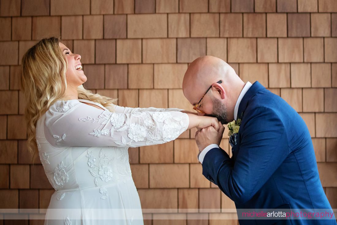 Hotel LBI wedding New Jersey groom kissing bride's hand