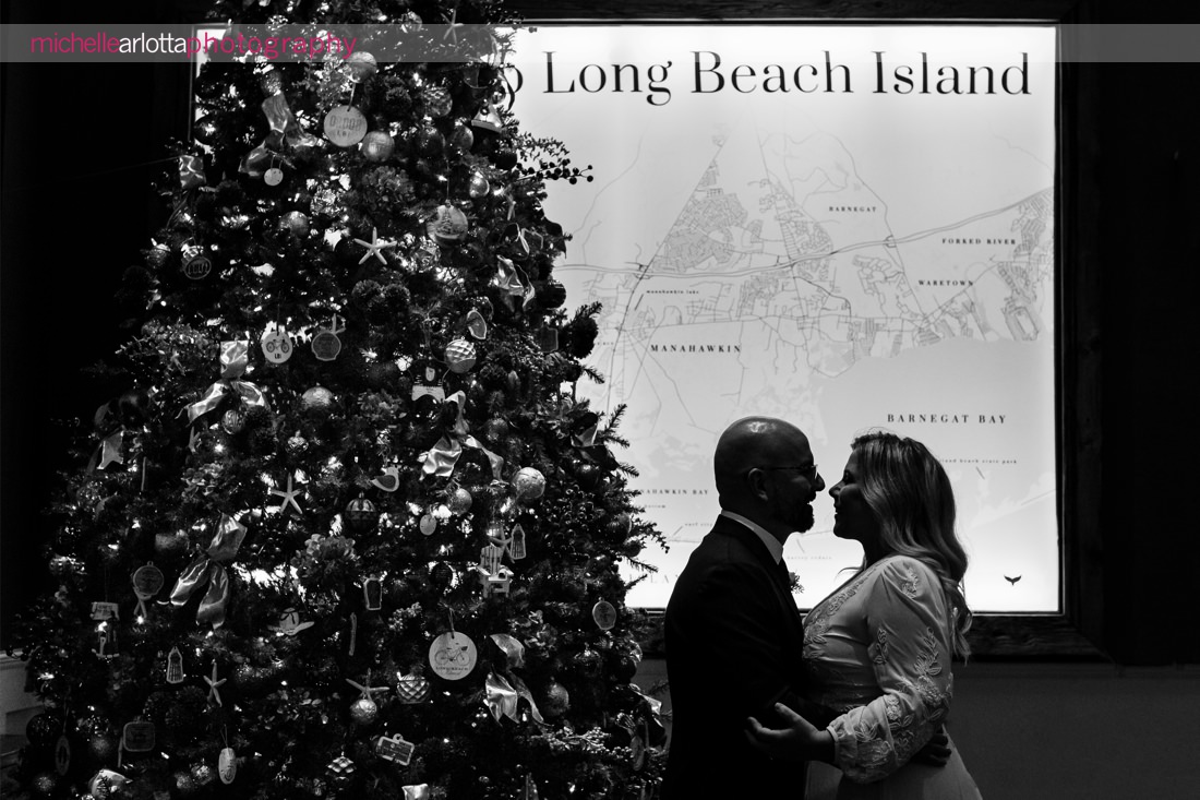 Hotel LBI wedding NJ bride and groom portrait with Long Beach Island map and Christmas tree