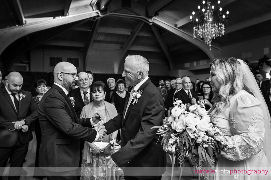 LBI indoor wedding ceremony NJ father of the bride shakes groom's hand at altar