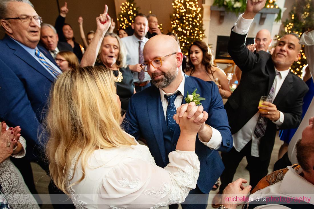 Hotel LBI wedding reception NJ dancefloor guests surround bride and groom during "Sweet Caroline"