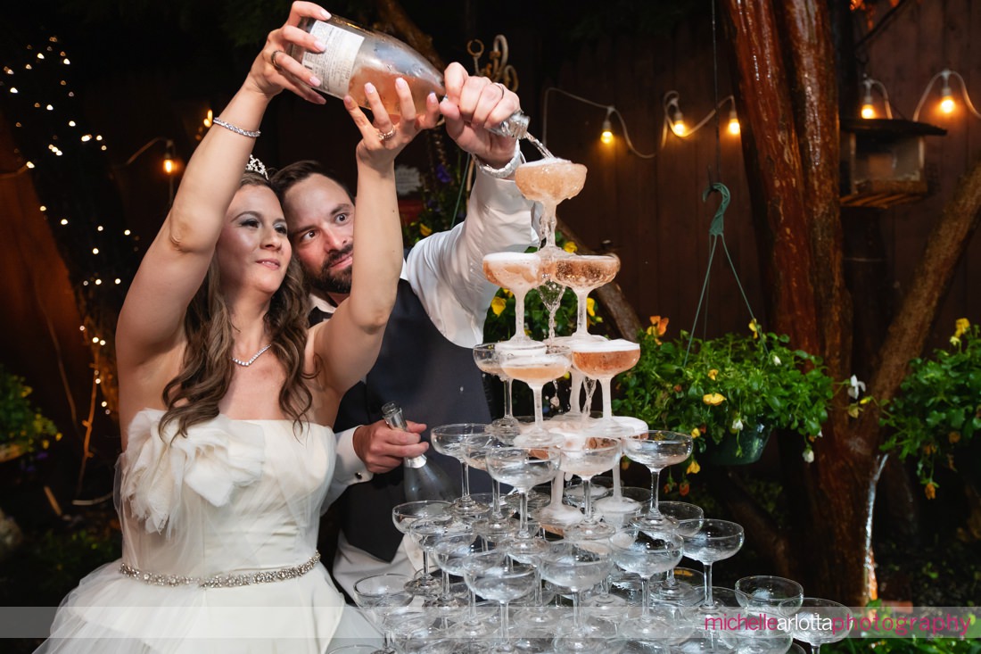 The Gables Inn LBI bride and groom pouring champagne on a champagne tower 