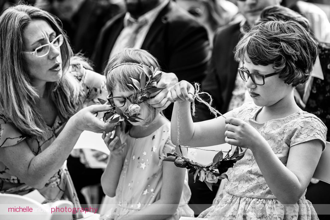 Mother adjusts flower crown on daughter during New Paltz wedding ceremony