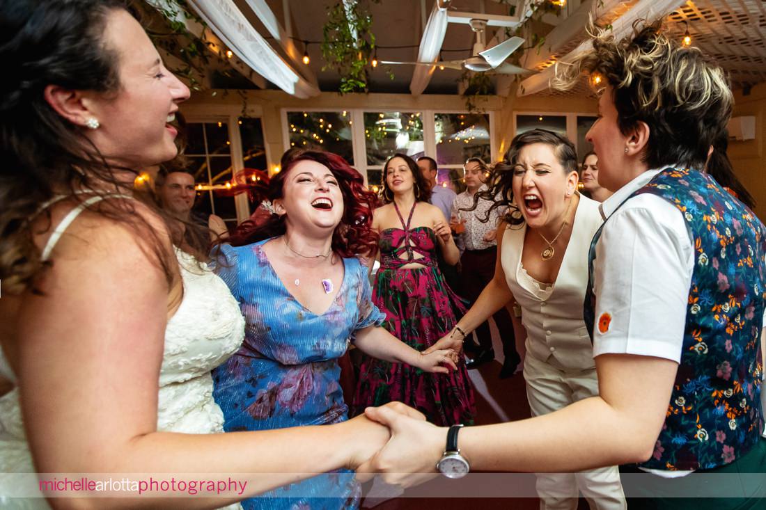 wedding guests having fun during two bride's reacting during Garvan's Gastropub wedding reception in Hudson Valley NY
