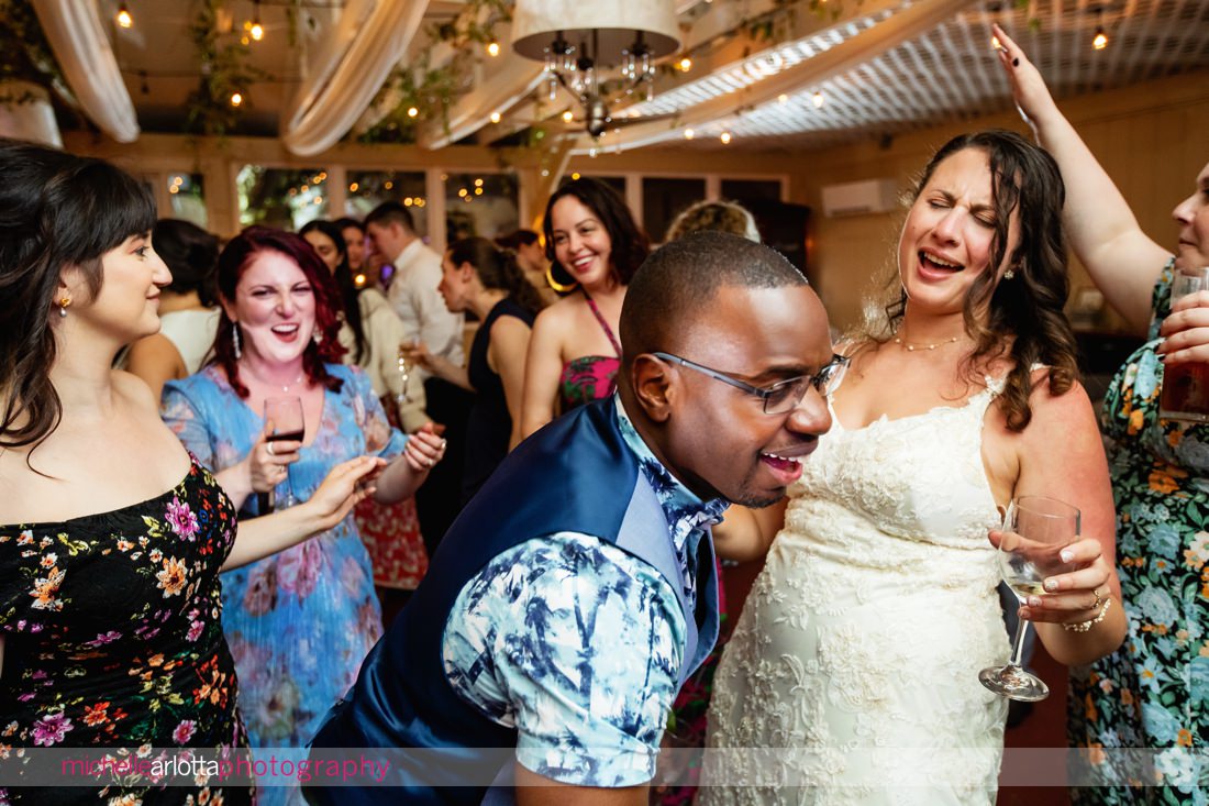 wedding guests having fun during two bride's reacting during Garvan's Gastropub wedding reception in New Paltz NY