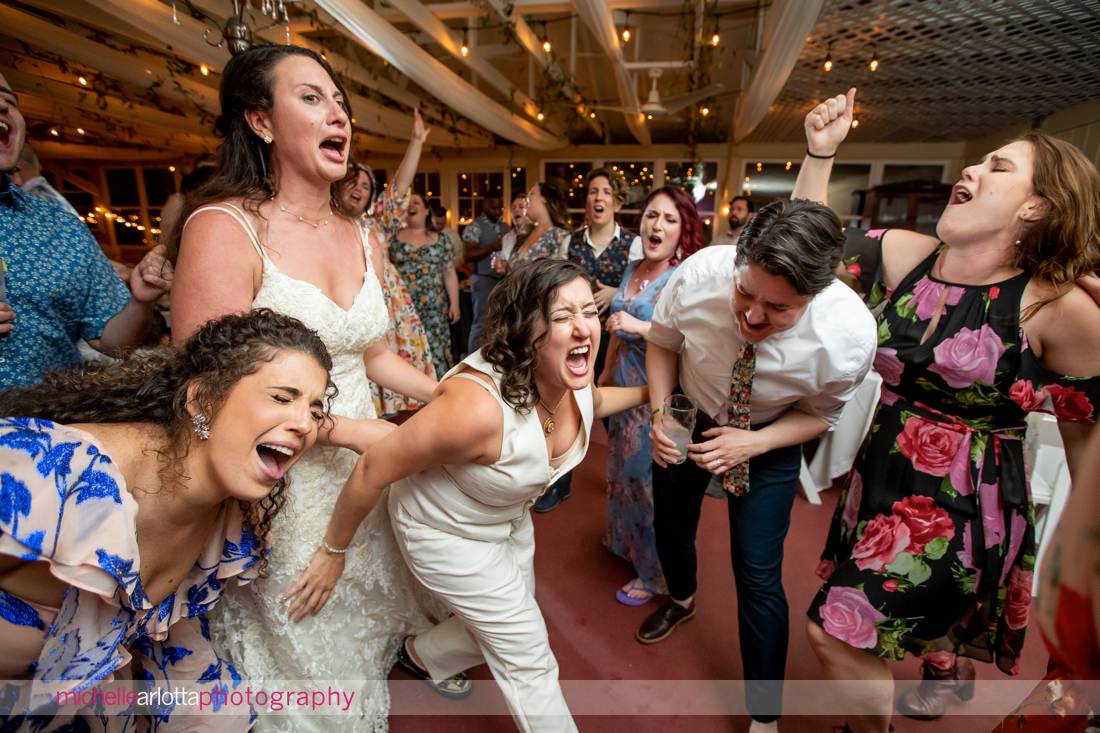 wedding guests having fun during two bride's reacting during Garvan's Gastropub wedding reception in New Paltz NY