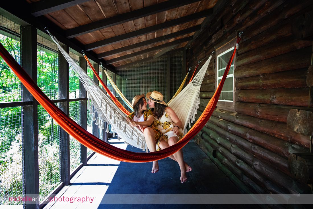 two brides-to-be in hammocks at Catskills Grateful Woods AirBNB engagement session
