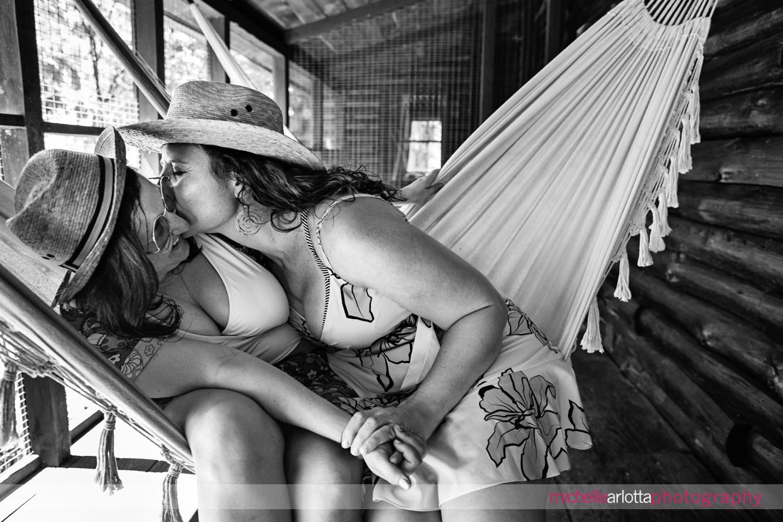 two brides-to-be in hammocks at Catskills Grateful Woods AirBNB engagement session