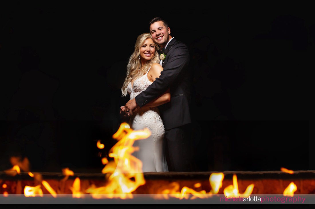 Perona Farms Refinery Summer NJ wedding bride and groom in front of fire