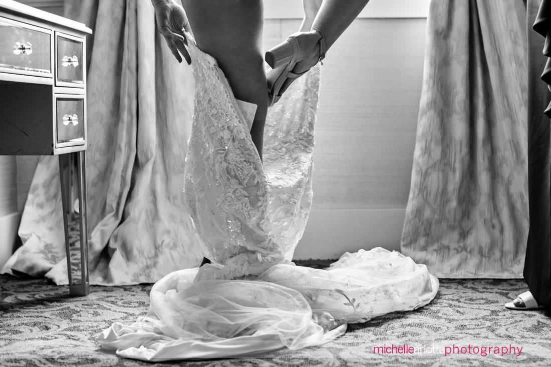 detail shot of bride putting foot into wedding dress at New Jersey wedding