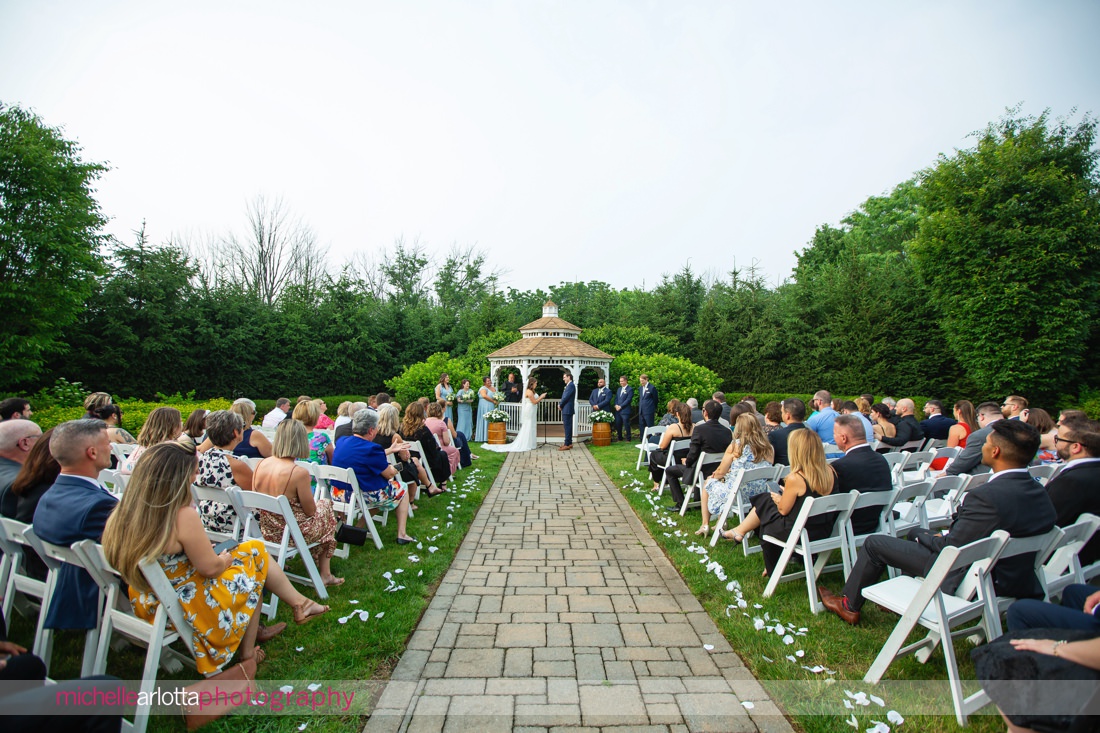 Outdoor ceremony at The Farmhouse NJ summer wedding wide angle view of ceremony site