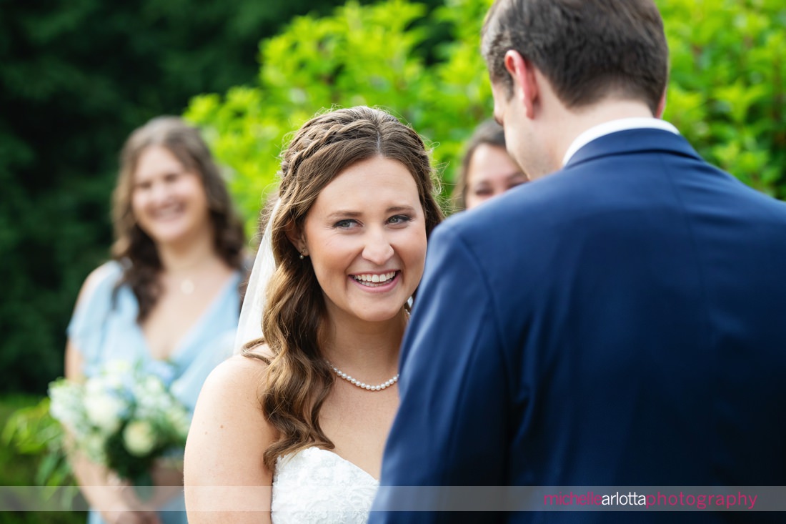 Outdoor ceremony at The Farmhouse NJ summer wedding bride laughing