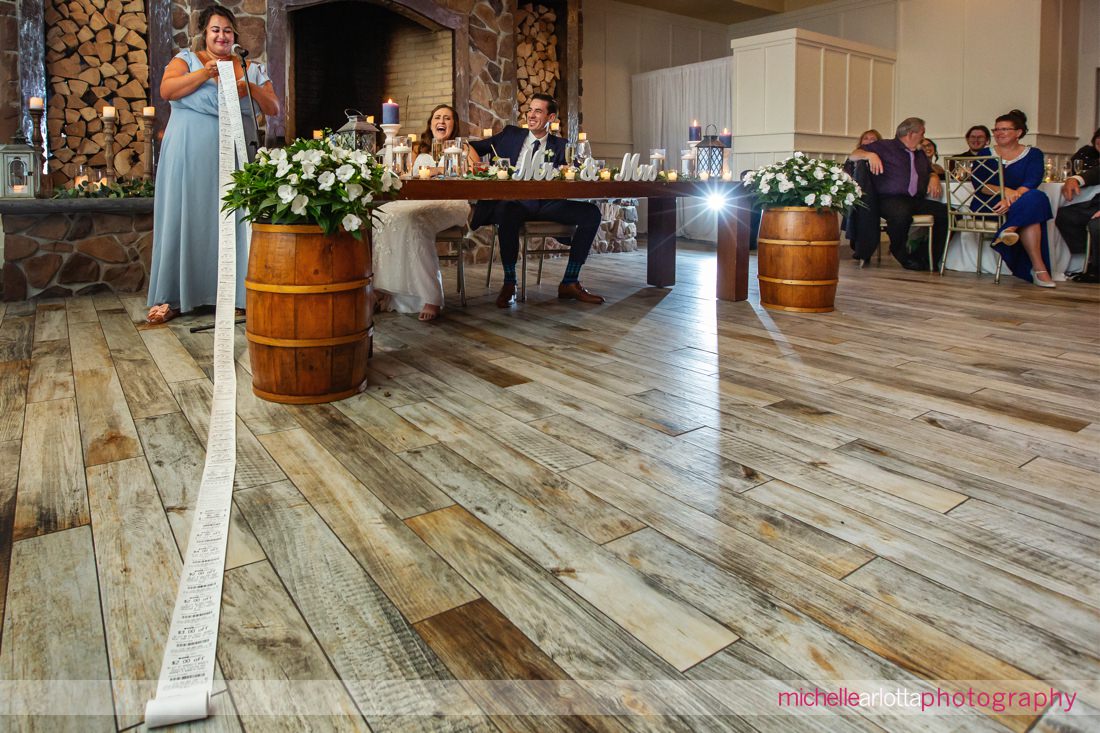 The Farmhouse NJ summer wedding reception toast by maid of honor with very long sheet of paper