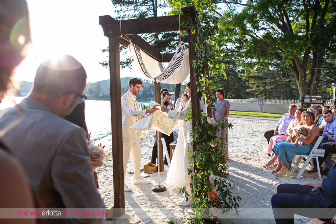 bride and groom under chuppah jewish NJ Lake Mohawk Country Club lakeside wedding ceremony