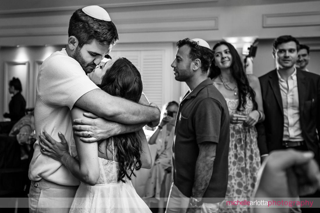 bride and groom embrace after hora during Lake Mohawk Country Club NJ Jewish Wedding reception