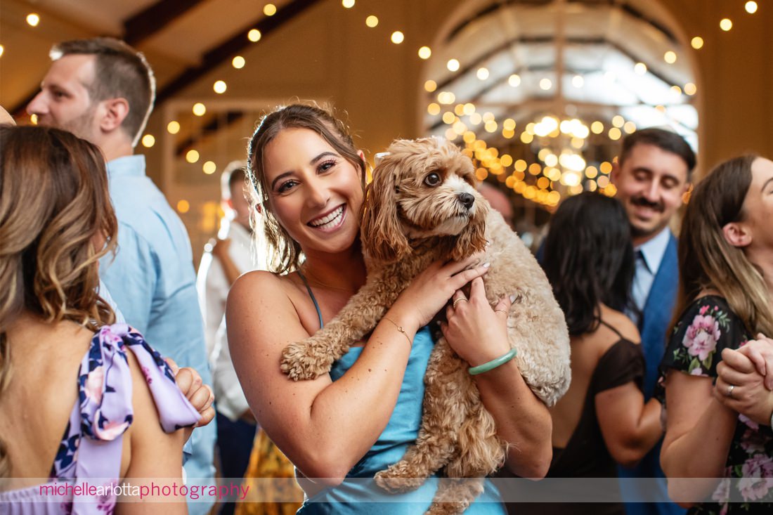wedding guests holds bride and groom's dog at Lake Mohawk Country Club New Jersey wedding