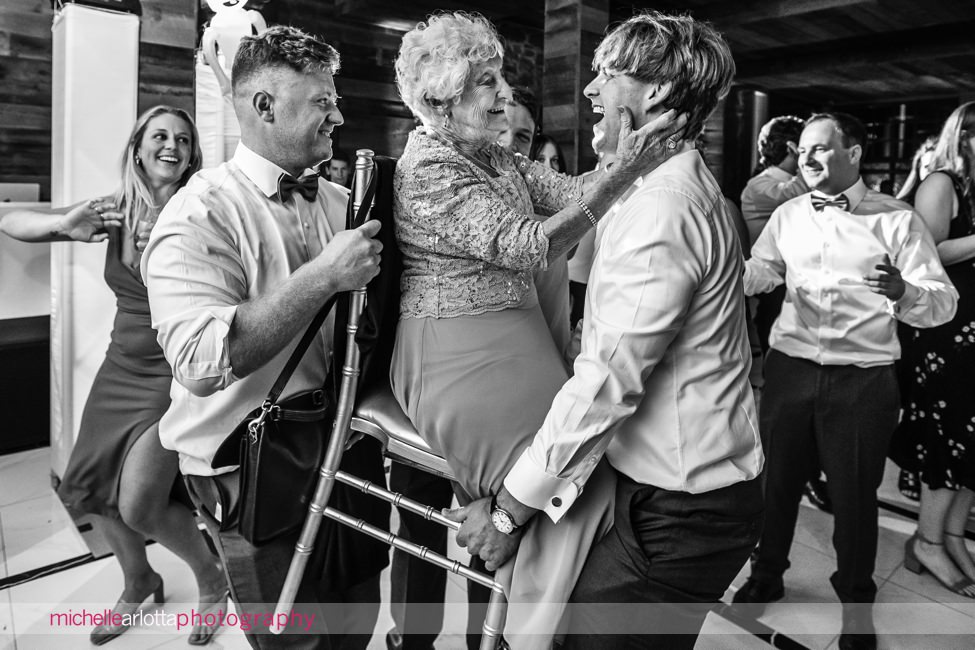Logan Inn New Hope PA wedding reception grandmother on a chair being picked up