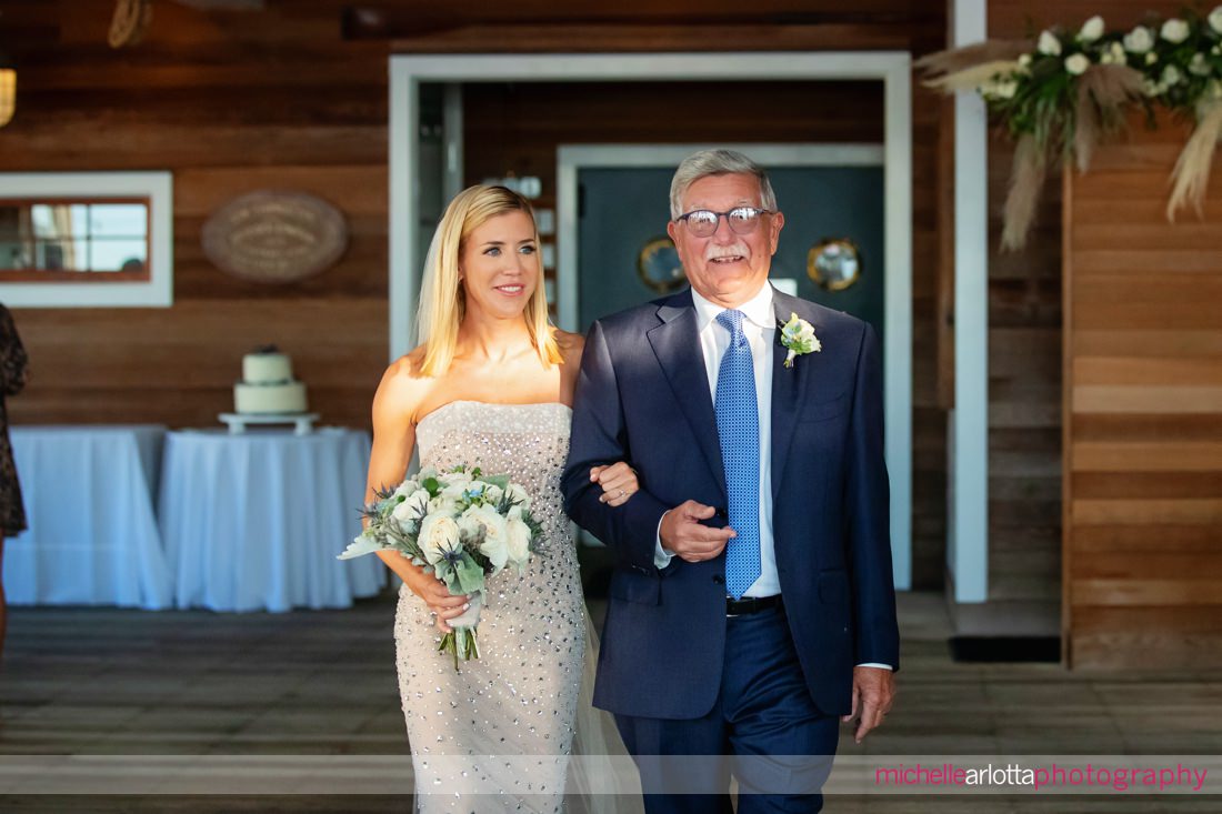 Parker's Garage LBI NJ wedding ceremony bride walks down the aisle with father