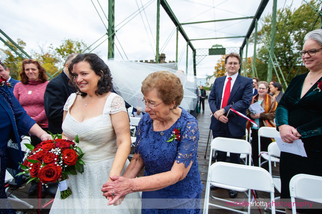 Nevius Street Bridge NJ wedding ceremony mother of the bride meets bride at end of aisle to hand over to groom