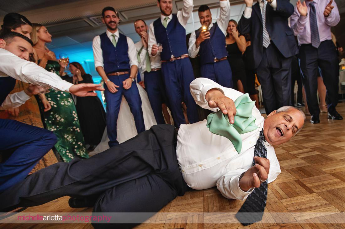 The Shore Club Spring Lake NJ wedding reception wedding guest on the floor dancing to the song 'shout'