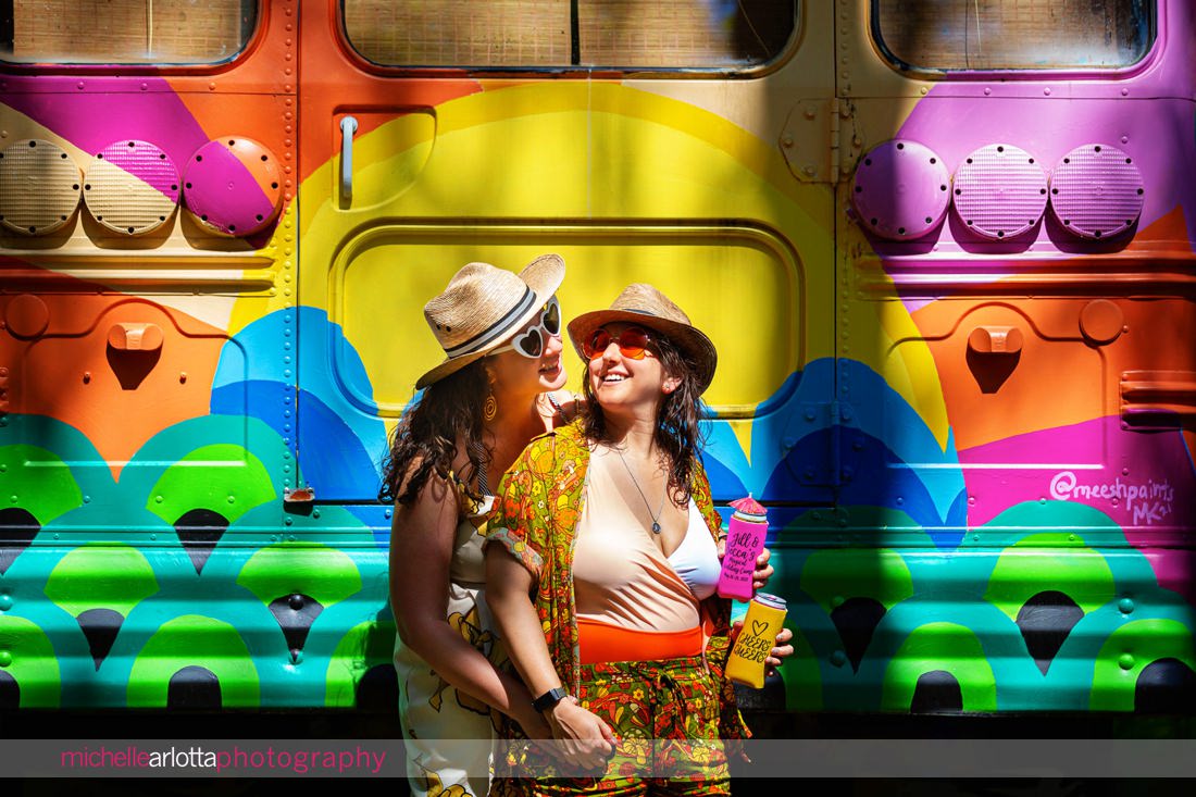 two brides in front of a colorful bus during their new paltz ny engagement session