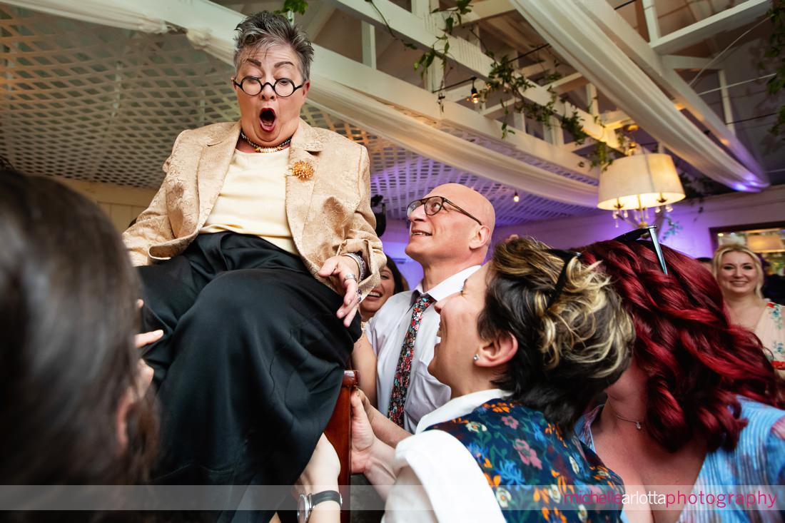mother of bride up in the chair during hora at Gavin's in new paltz ny wedding