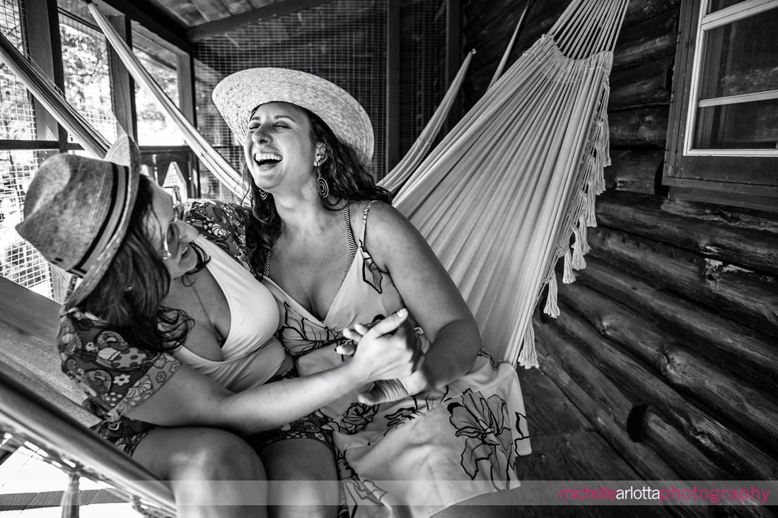 two brides laughing on a hammock during new paltz ny engagement session