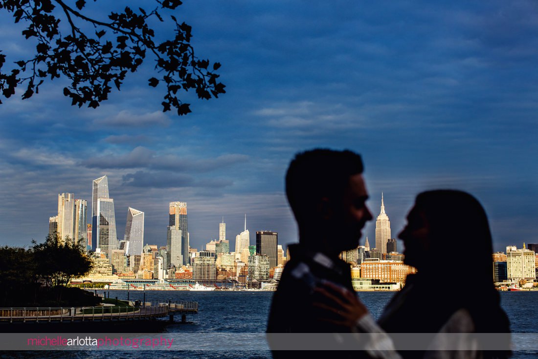 bride and groom silhouetted against NYC skyline