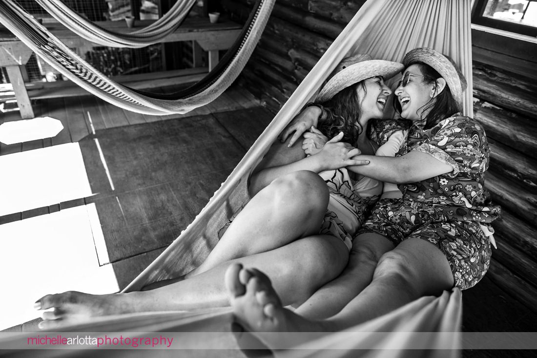 two brides embraced in a hammock during upstate NY engagement session