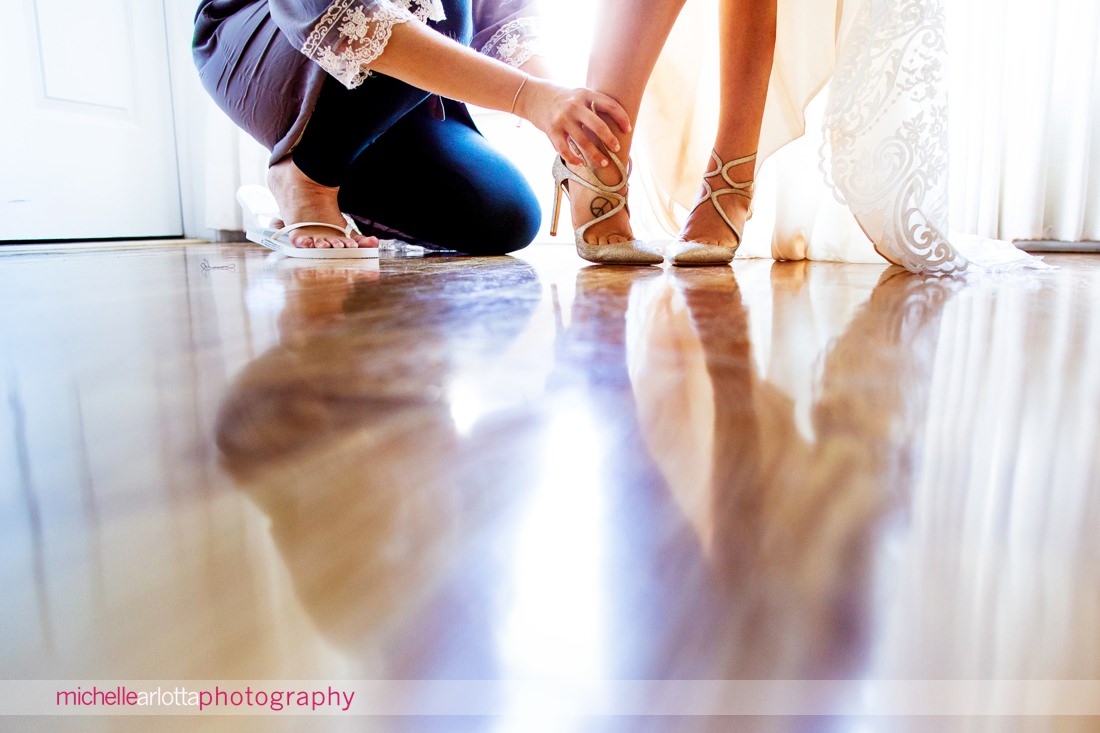 bride getting shoes on at bear brook valley nj wedding