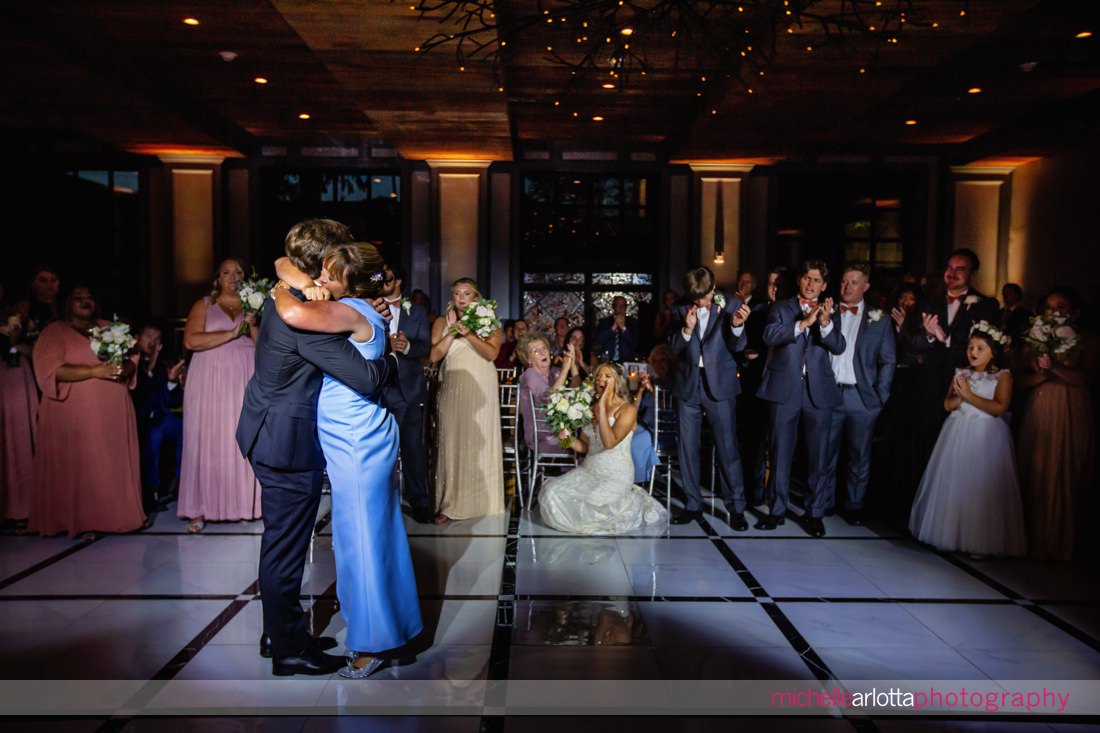 mother of groom and groom embrace during first dance at Logan inn at new hope pa wedding