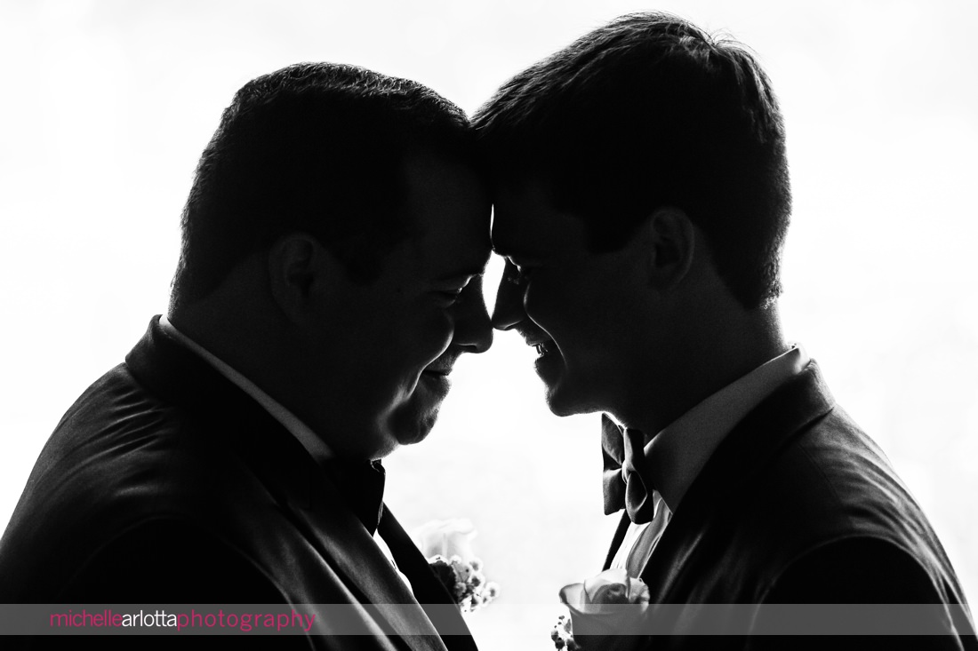 silhouette of two grooms nestled in close together