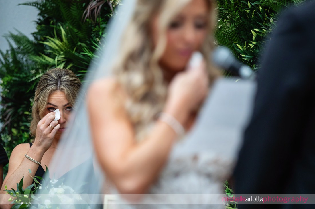 maid of honor wipes tear at the same time the bride does during perona farms refinery wedding ceremony