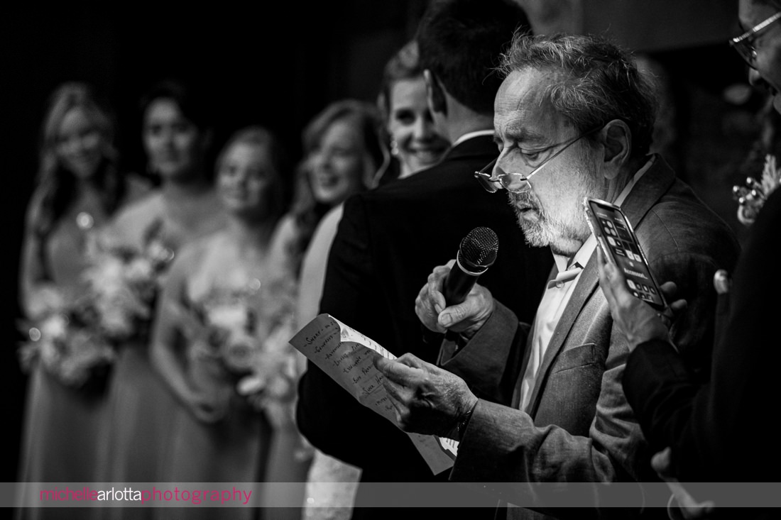 officiant reads by the light of a cell phone during Waterloo village nj wedding
