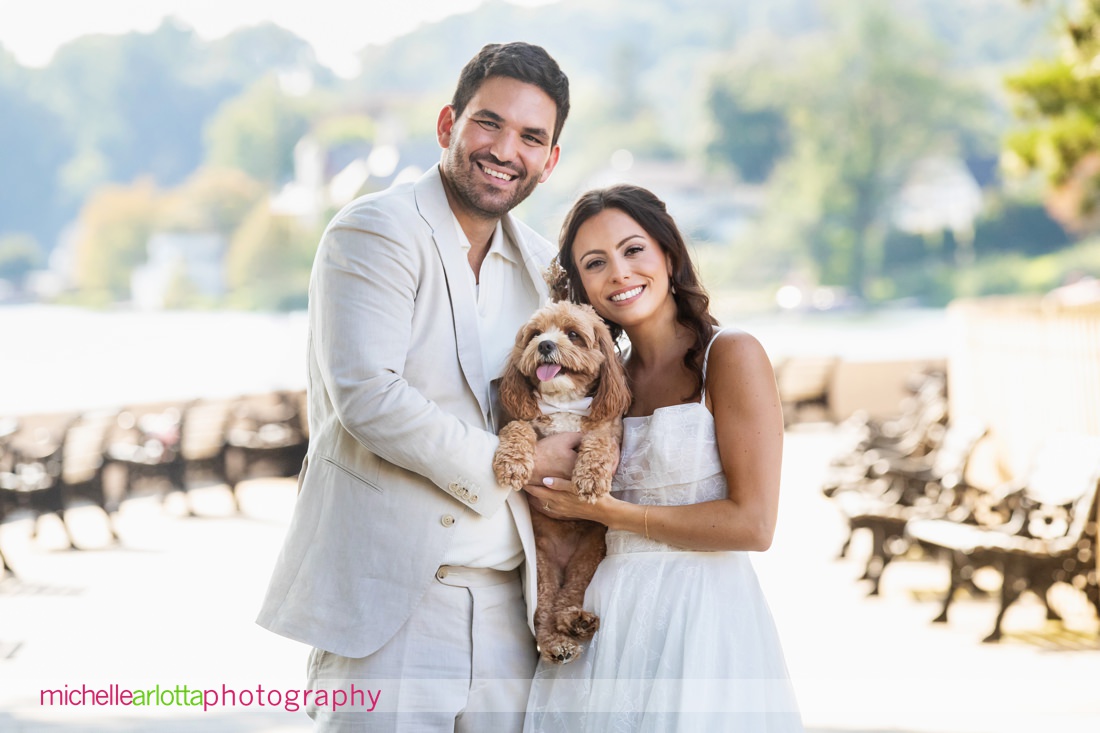 bring all the dogs nj Lake Mohawk country club wedding  bride and groom pose holding dog