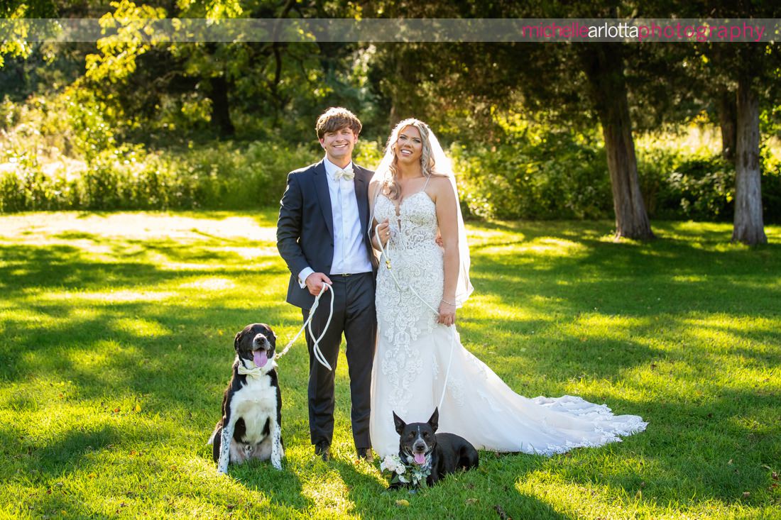 bring all the dogs new hope PA wedding bride and groom pose with two dogs at bowman's hill wildflower preserve