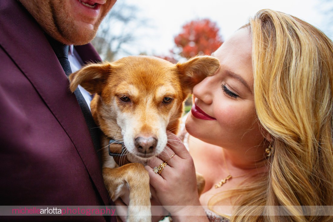 bring all the dogs jersey city NJ wedding bride and groom snuggle into dog during portraits