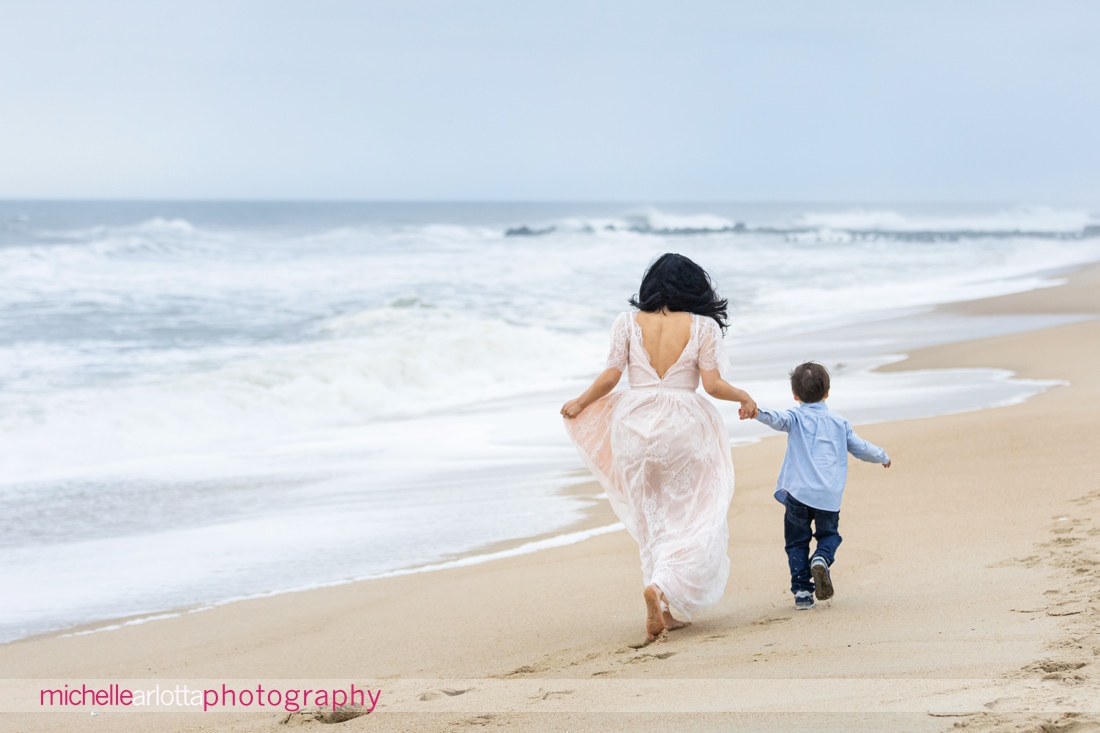 mother and son run down the beach in New Jersey