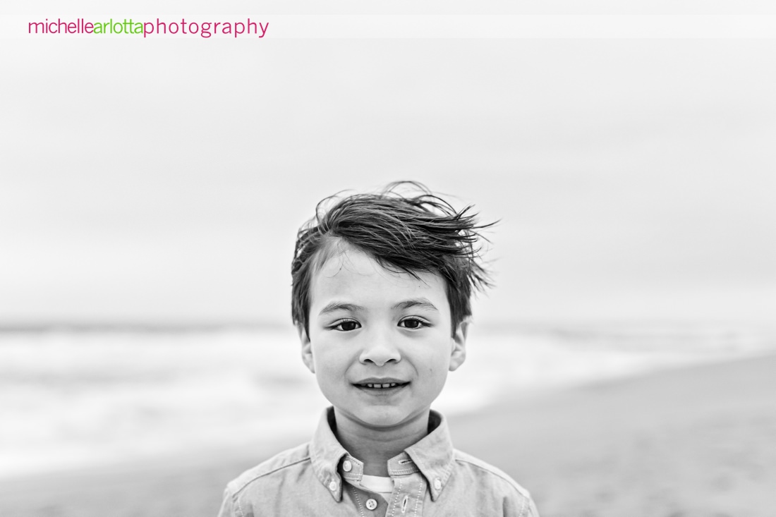 black and white portrait from the shoulders up of young boy on the beach in New Jersey