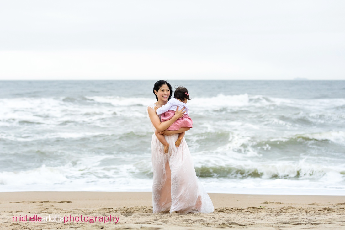 mother and daughter in pink on the beach in Asbury Park, NJ family portrait session