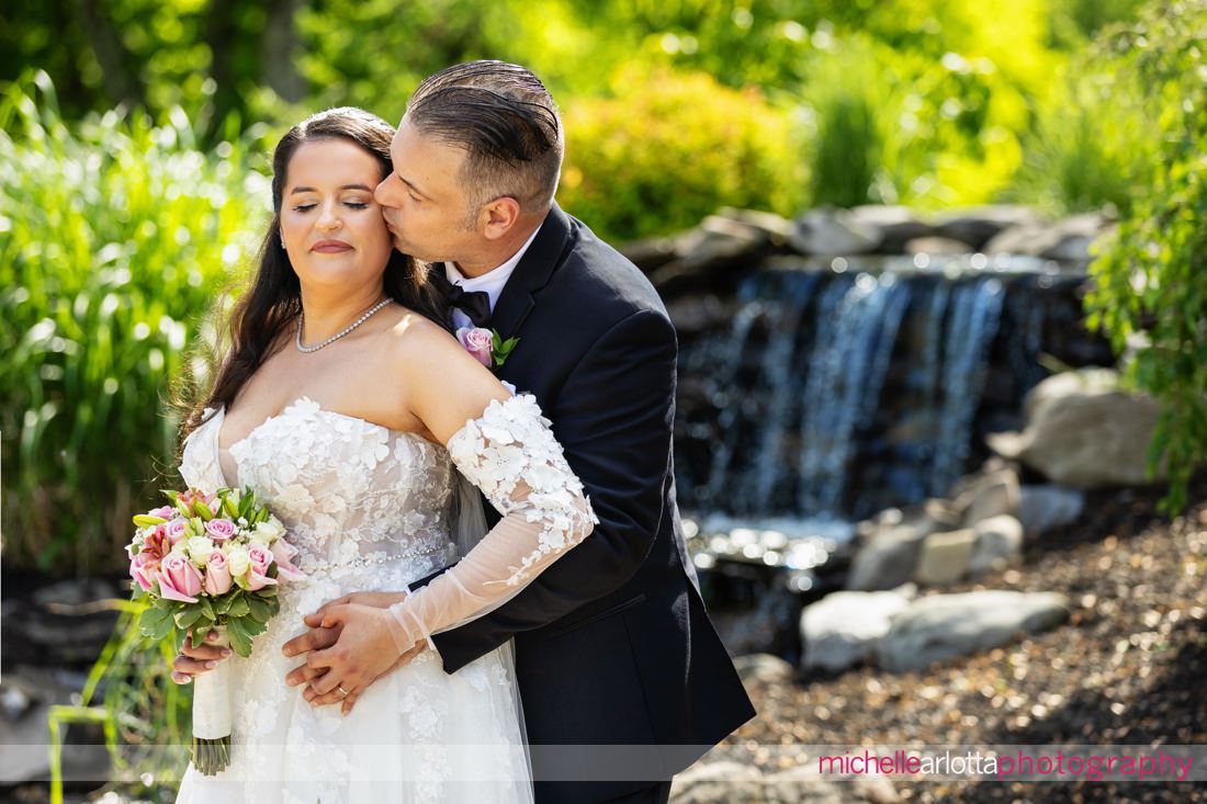 Venue at Winding Hills wedding Montgomery NY bride and groom portrait in front of waterfall