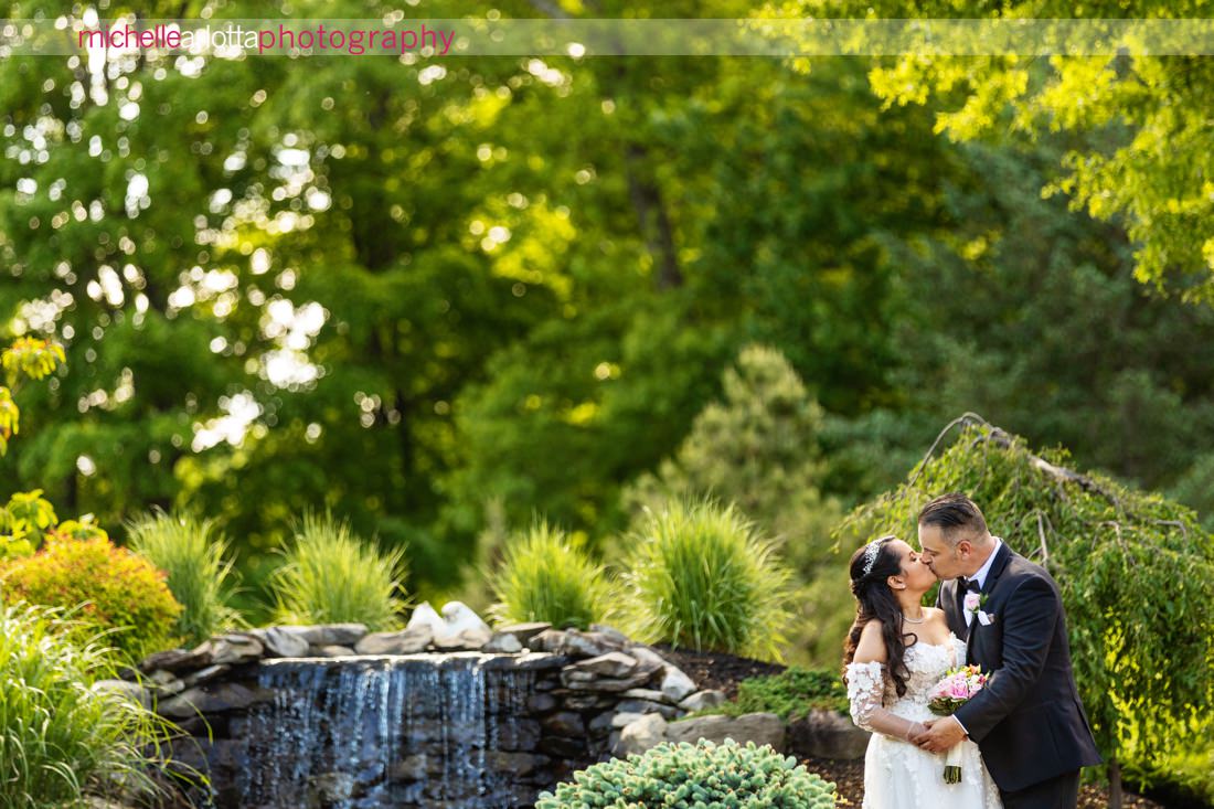 Venue at Winding Hills wedding Montgomery NY bride and groom portrait in front of waterfall