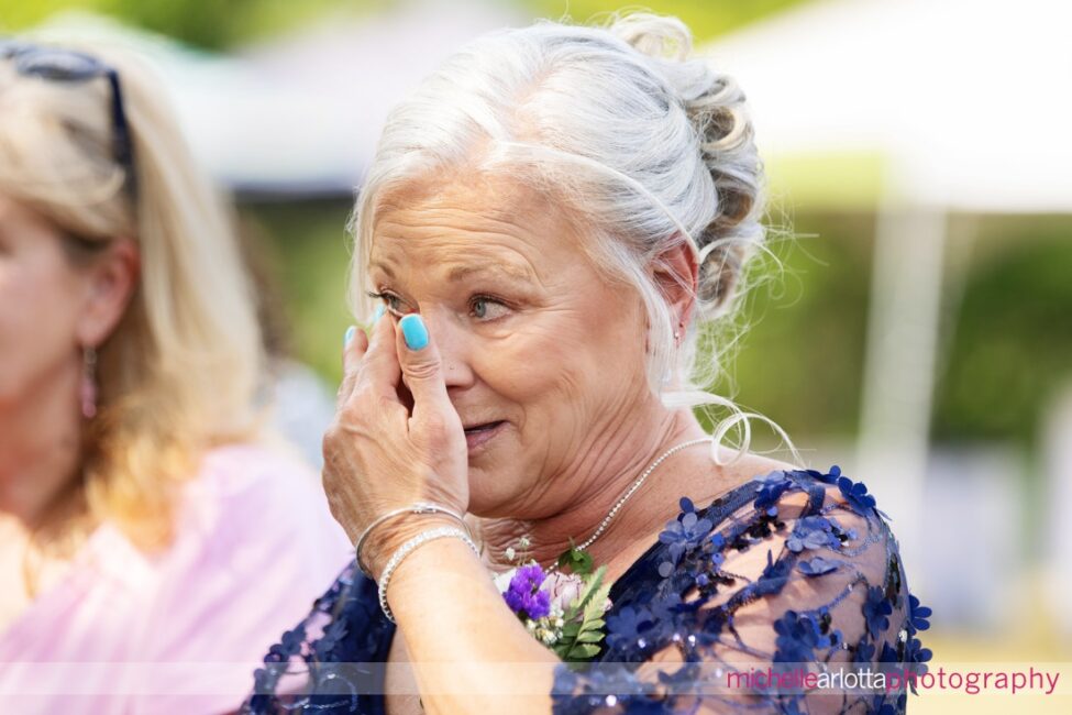 South Jersey Hammonton Summer Backyard wedding mother of the groom wipes a tear away during the ceremony