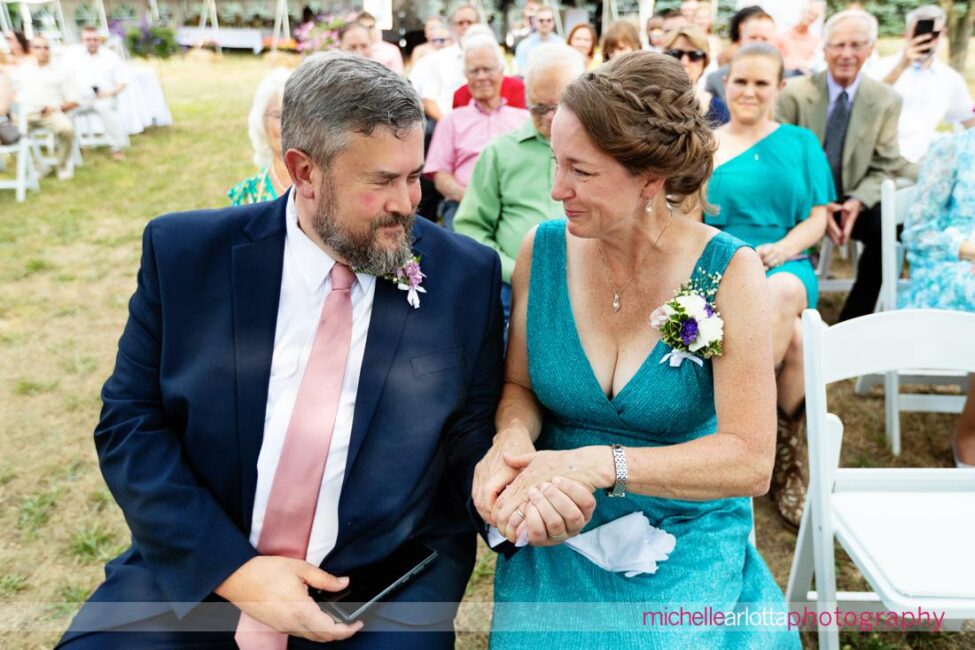 South Jersey Hammonton Summer Backyard wedding ceremony parents of the bride warming the rings