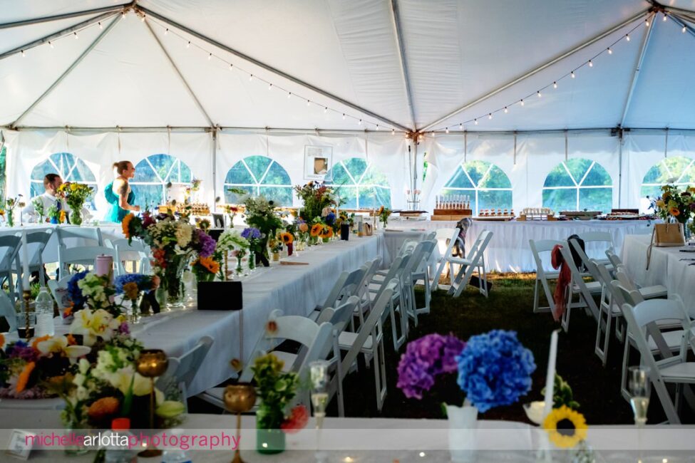 South Jersey Hammonton Summer Backyard wedding reception dog sniffing out the food under the tent