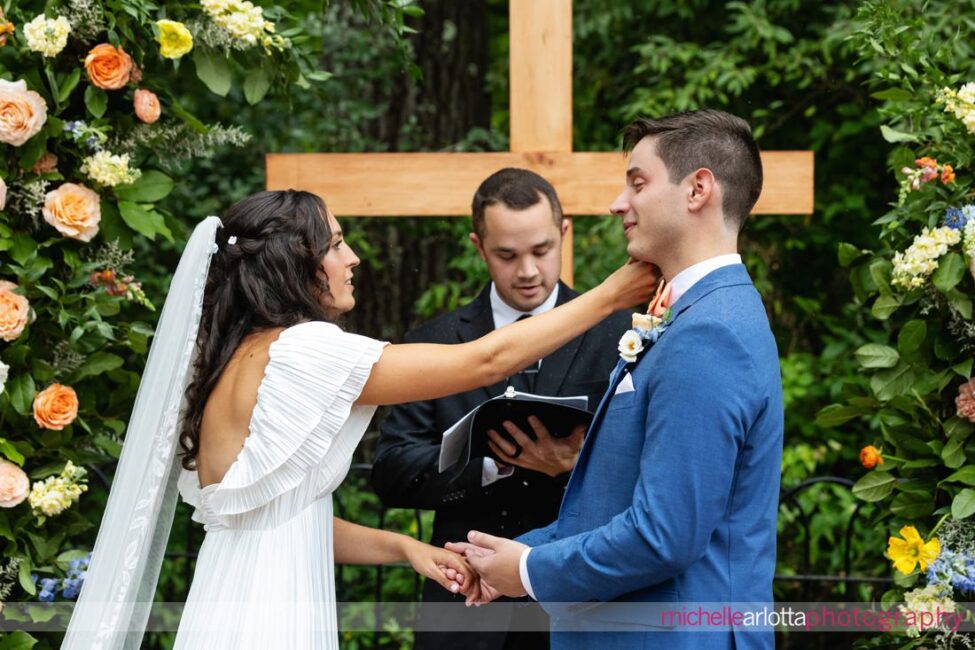 Landmark Venues Hotel Du Village New Hope PA outdoor wedding bride wipes tear from groom's face during vows