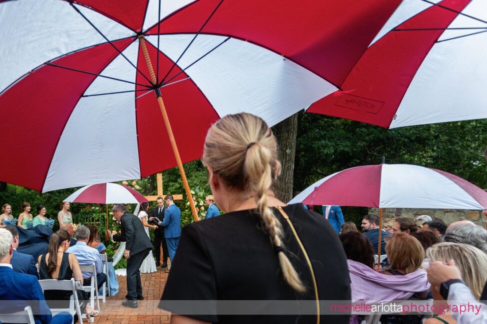 Landmark Venues Hotel Du Village New Hope PA outdoor wedding ceremony umbrellas being brought out to guests